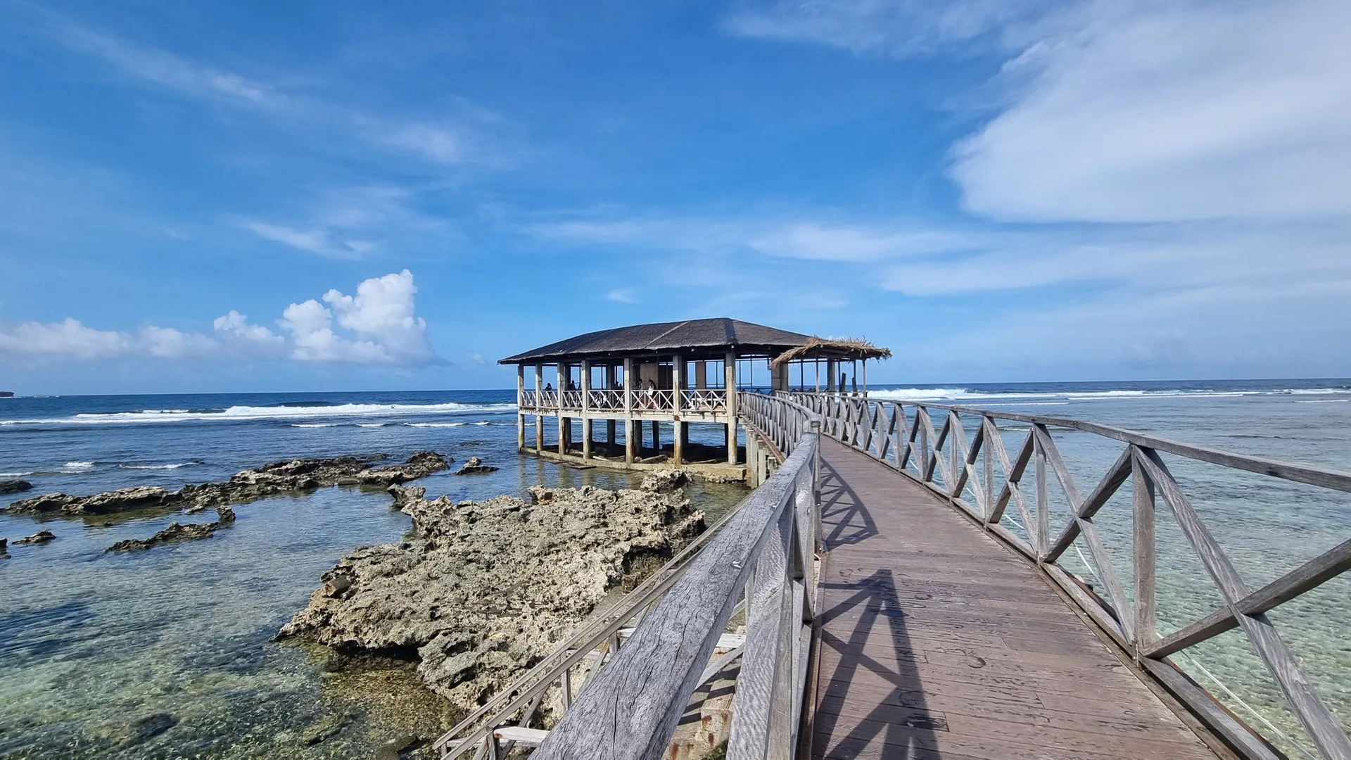 The Cloud 9 pier at low tide over the exposed reef